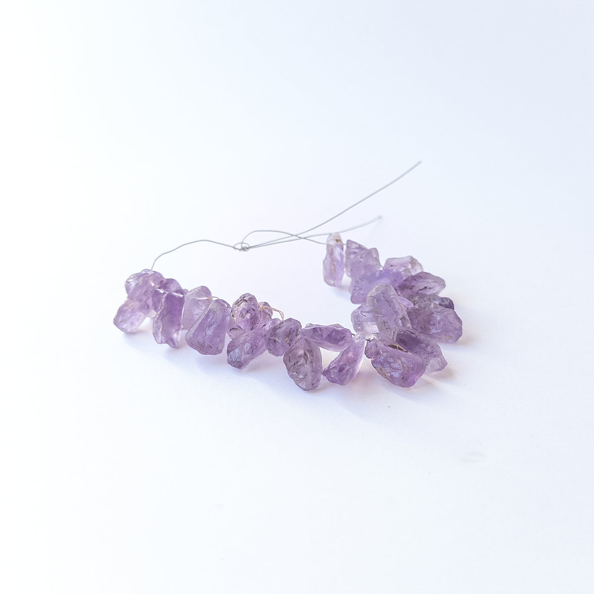 Authentic Amethyst rough gemstone beads displaying deep purple tones and organic uncut texture.
