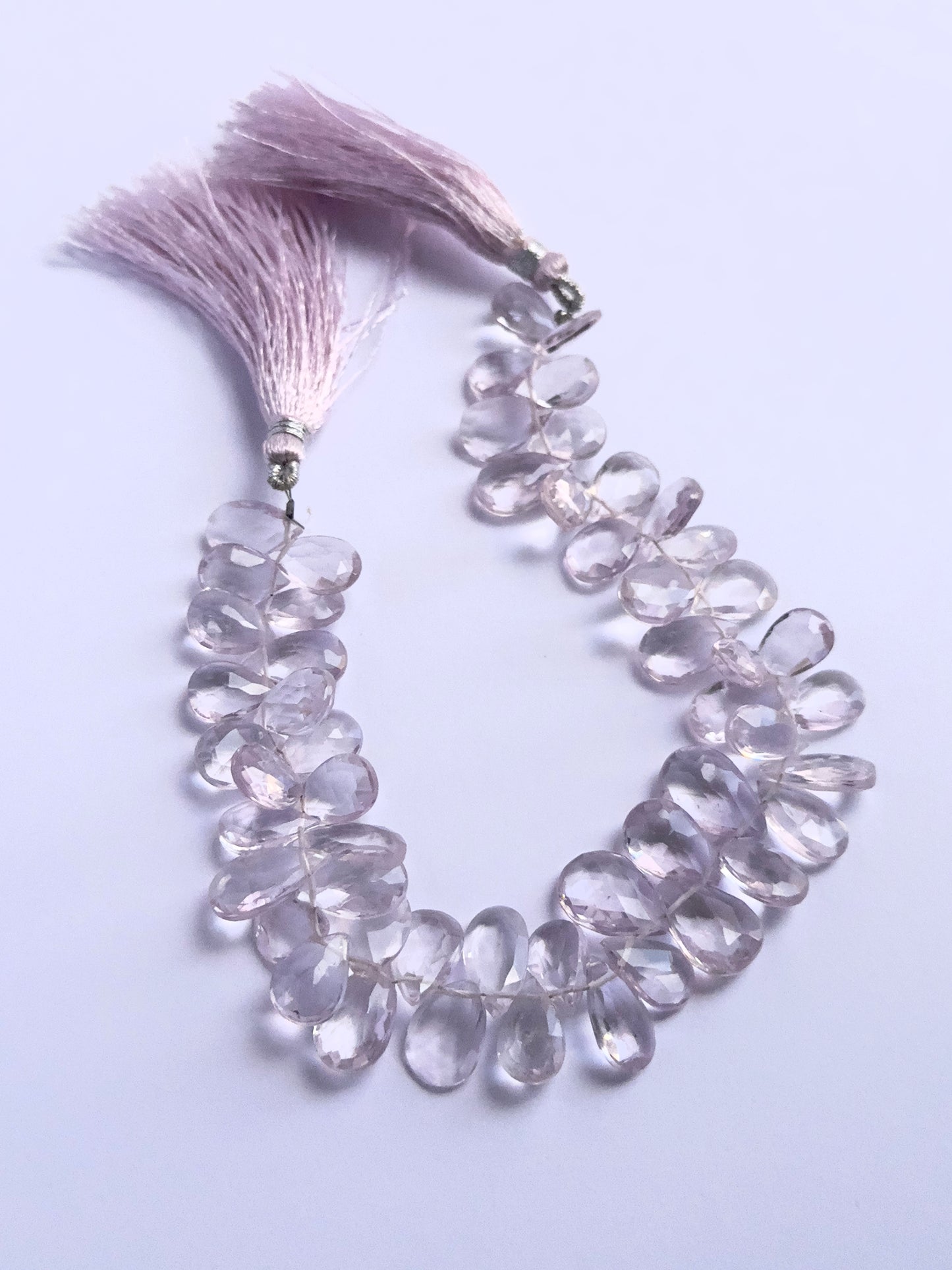 Stone beads in a strand of Amethyst, highlighting their polished facets and 7.5–8.5mm size.