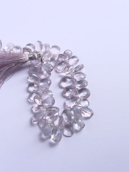 Handmade jewellery components featuring Amethyst faceted briolette beads strung neatly together.