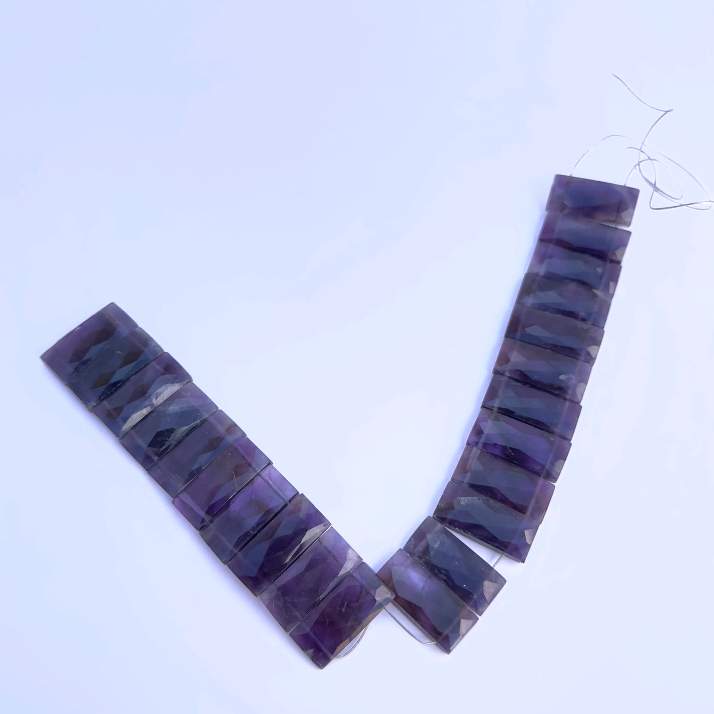 A dial gauge measures the Amethyst faceted rectangle 21×9mm gemstone.