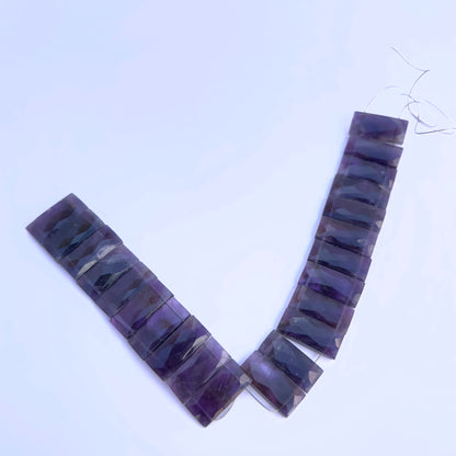 A dial gauge measures the Amethyst faceted rectangle 21×9mm gemstone.