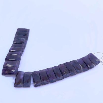 Close-up of Amethyst gemstone beads showing faceted cut and polished surface.