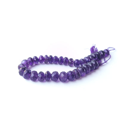 Amethyst faceted rondelle stone beads arranged neatly in a 22cm strand with natural purple brilliance.