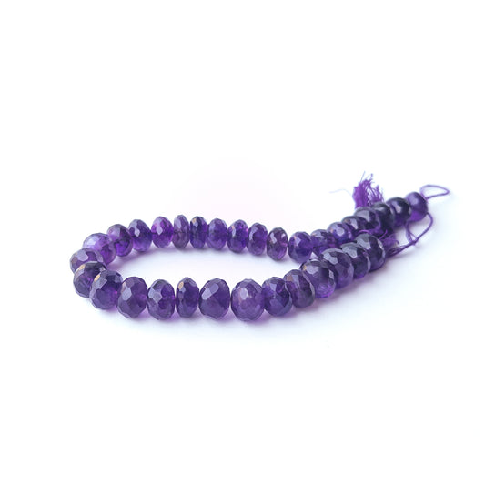 Amethyst faceted rondelle stone beads arranged neatly in a 22cm strand with natural purple brilliance.