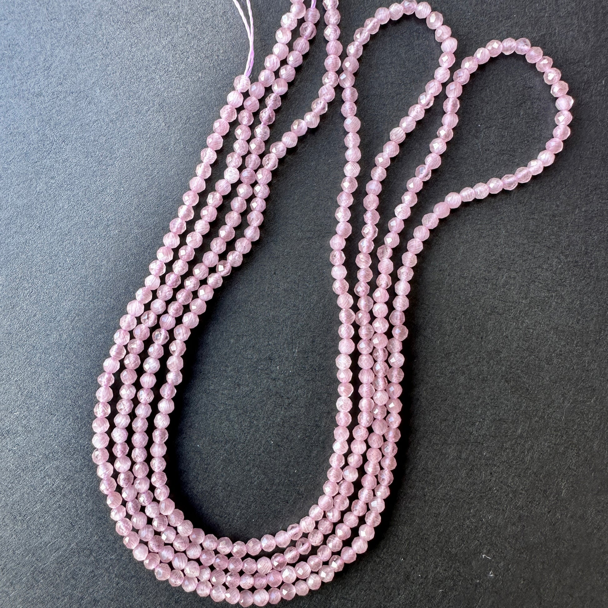 Stone beads in rich pink violet tones with precision-cut facets, ideal for DIY jewellery and layering designs.