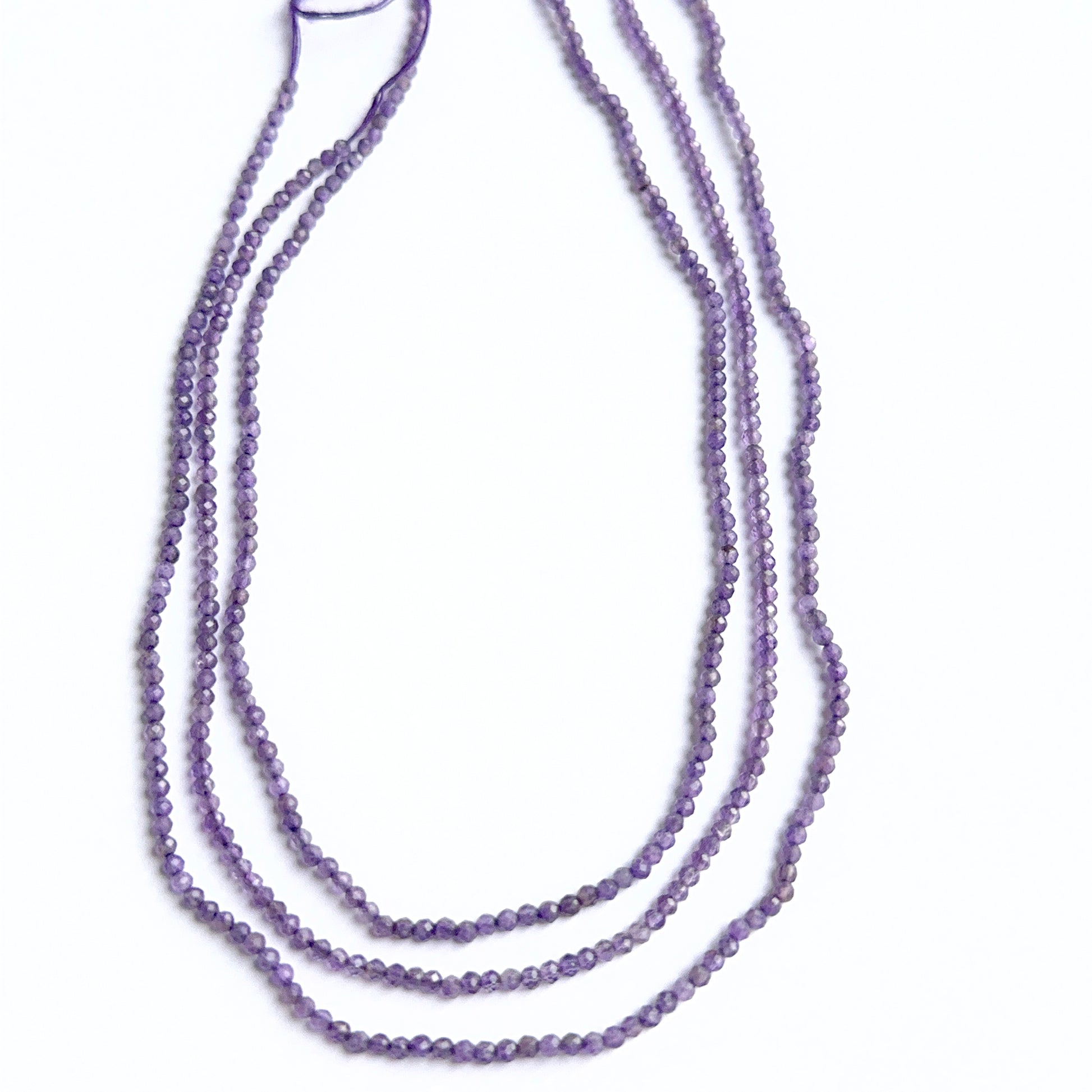 Amethyst faceted rondelles photographed to show brilliance, depth of colour and gemstone quality.