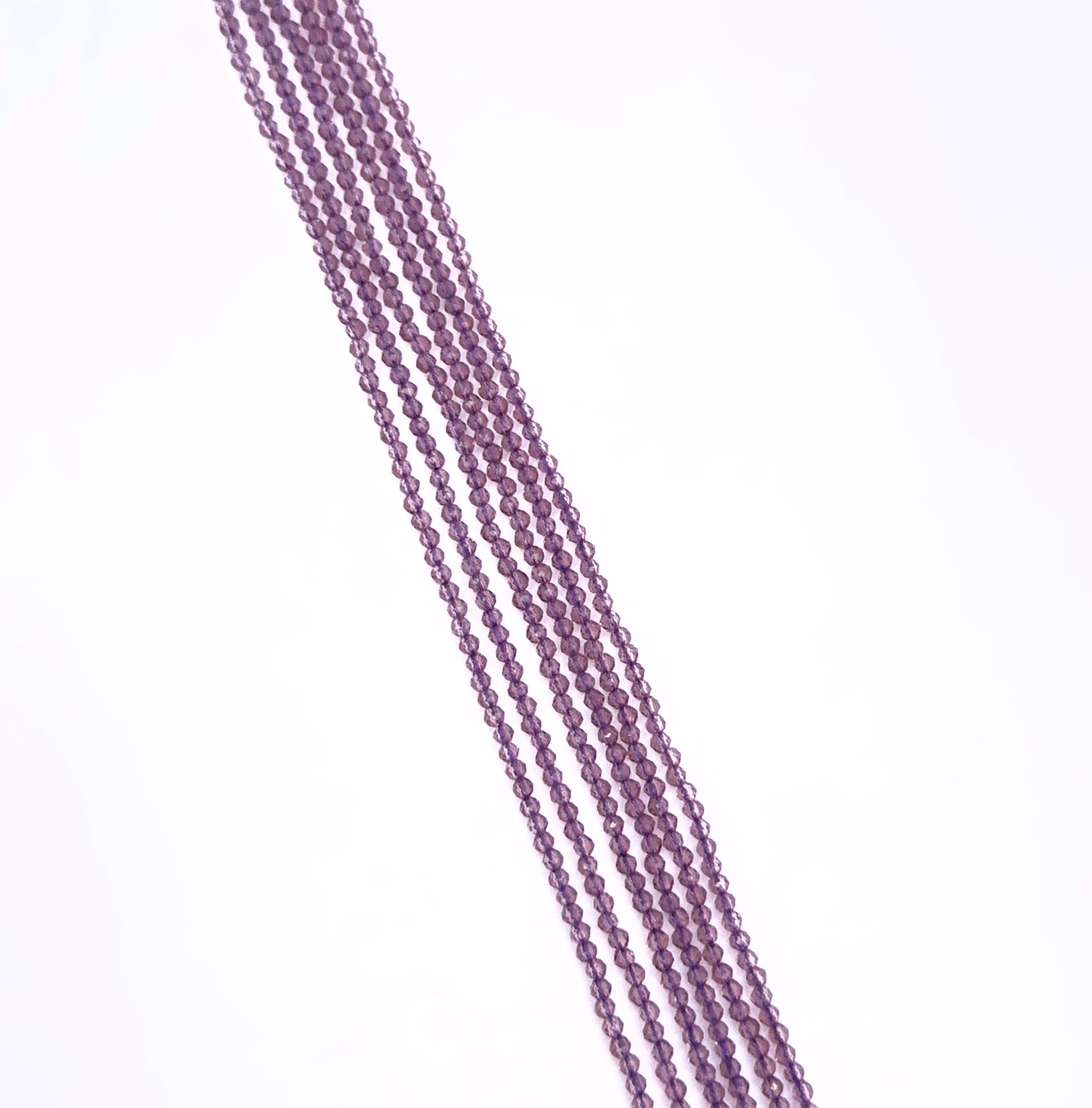 Close-up of Chalcedony gemstone beads showing faceted cut and translucent glow.