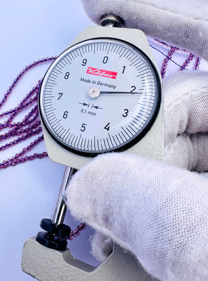 A dial gauge measures the Chalcedony faceted rondelle 2.2mm gemstone.