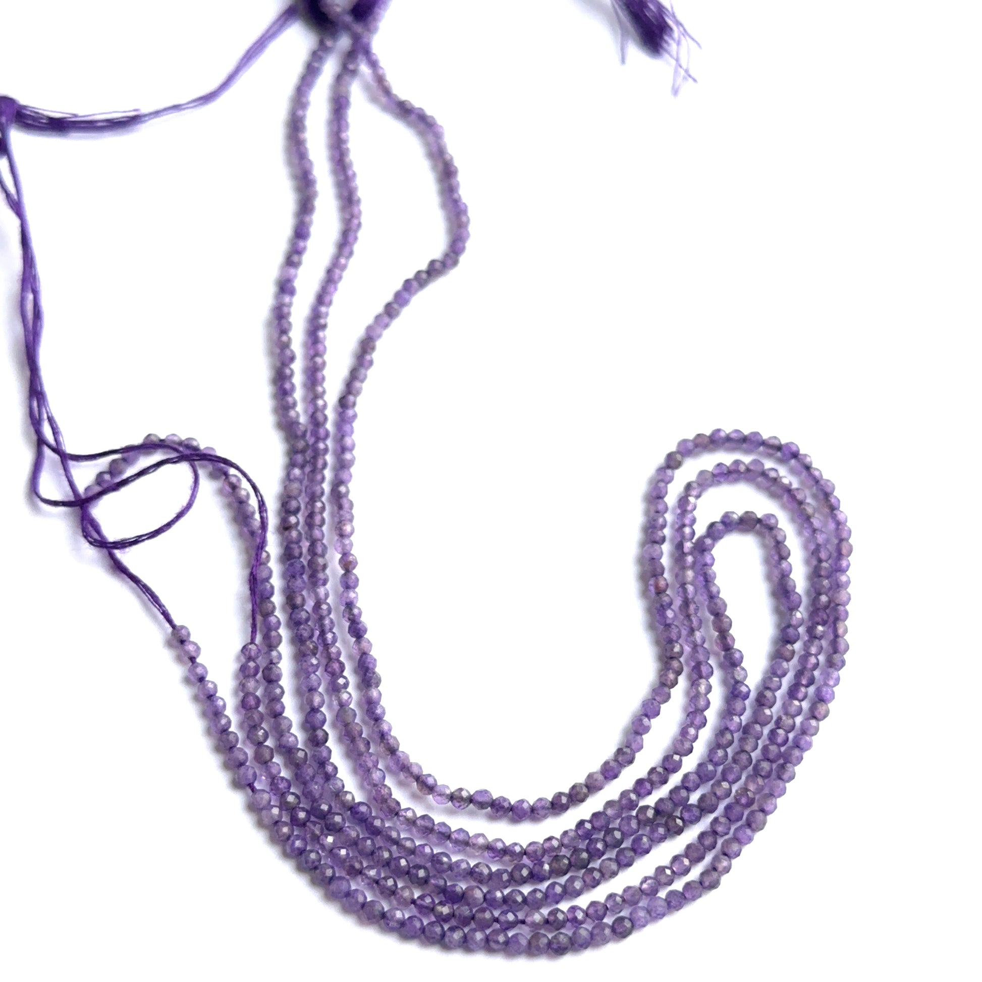 Faceted amethyst beads displayed with shimmering surfaces ideal for natural gemstone jewellery making.