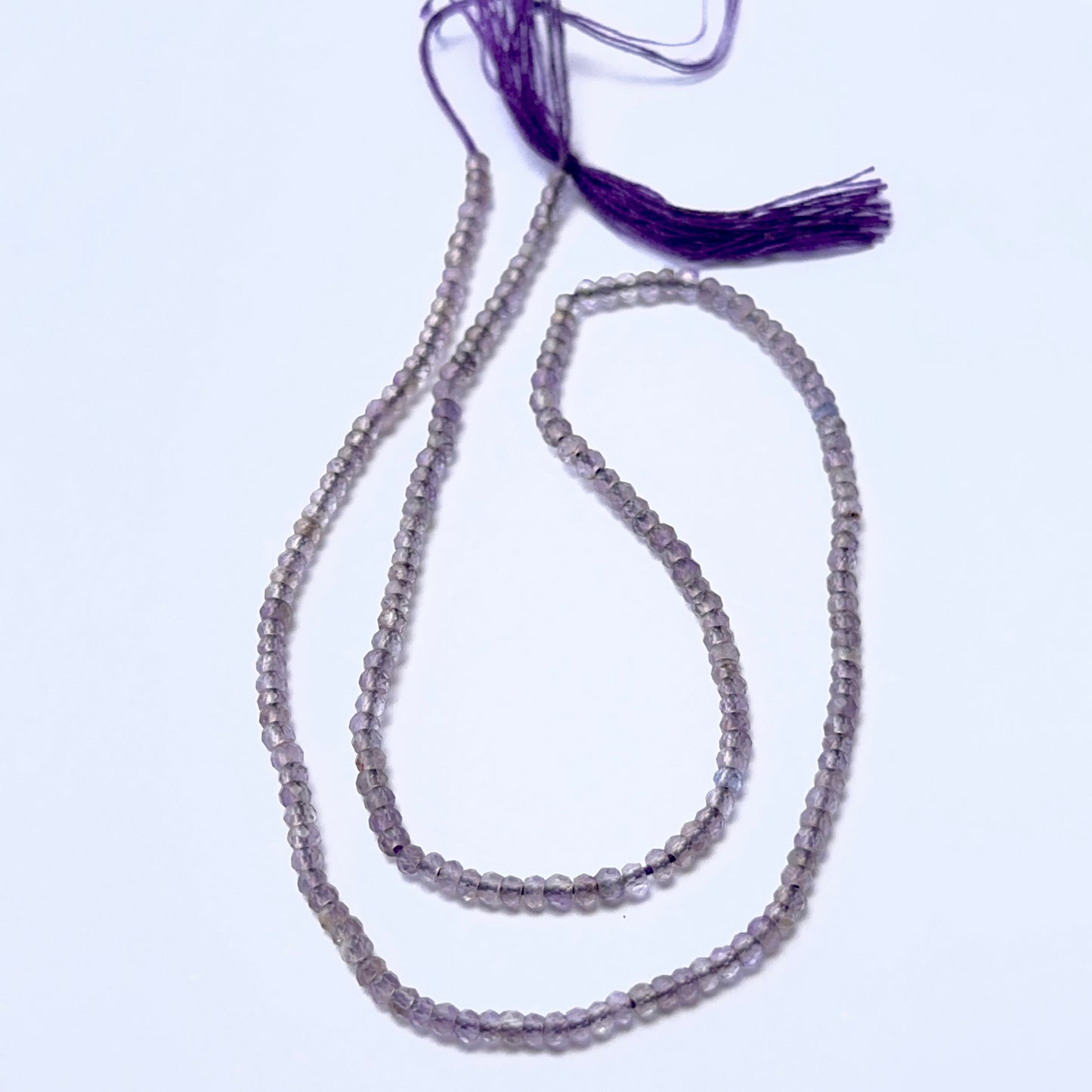 Close‑up of Amethyst stone beads in tiny faceted rondelle cut, highlighting shine and clarity for handmade jewellery components.