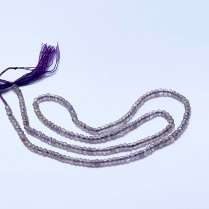 Amethyst 2.4mm faceted rondelle beads arranged on a strand, showing crisp faceting and rich purple tones.