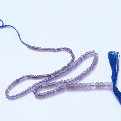 Faceted amethyst beads displayed with shimmering surfaces ideal for natural gemstone jewellery making.