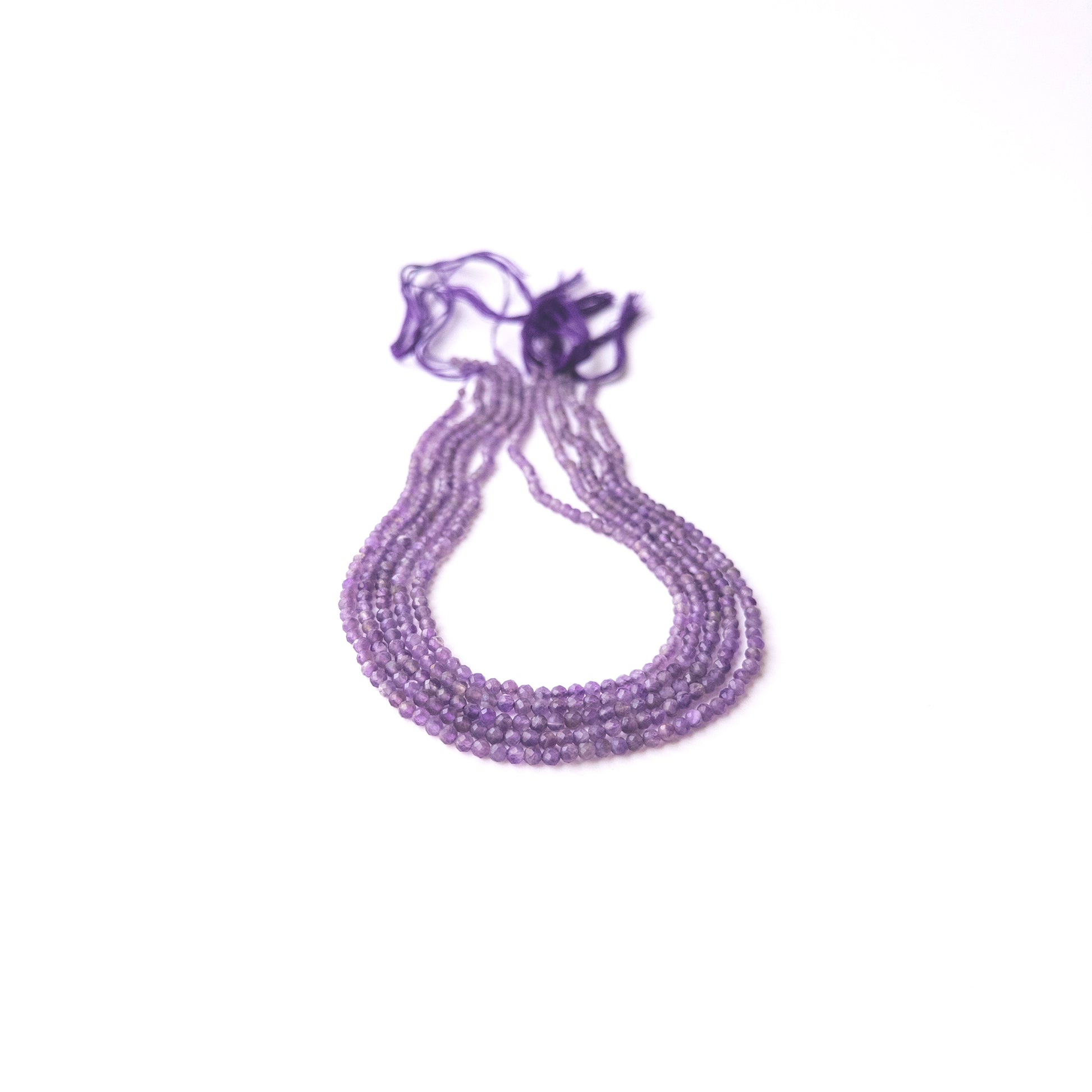 Close‑up of Amethyst faceted rondelle beads highlighting sparkle, clarity, and quality for DIY jewellery making.
