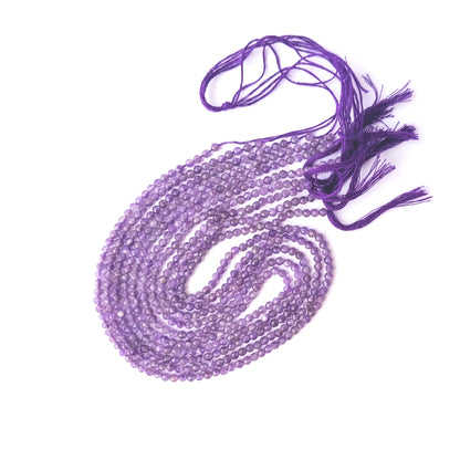 Genuine Amethyst gemstone beads in faceted rondelle cut, displaying polish, texture, and deep purple hues.