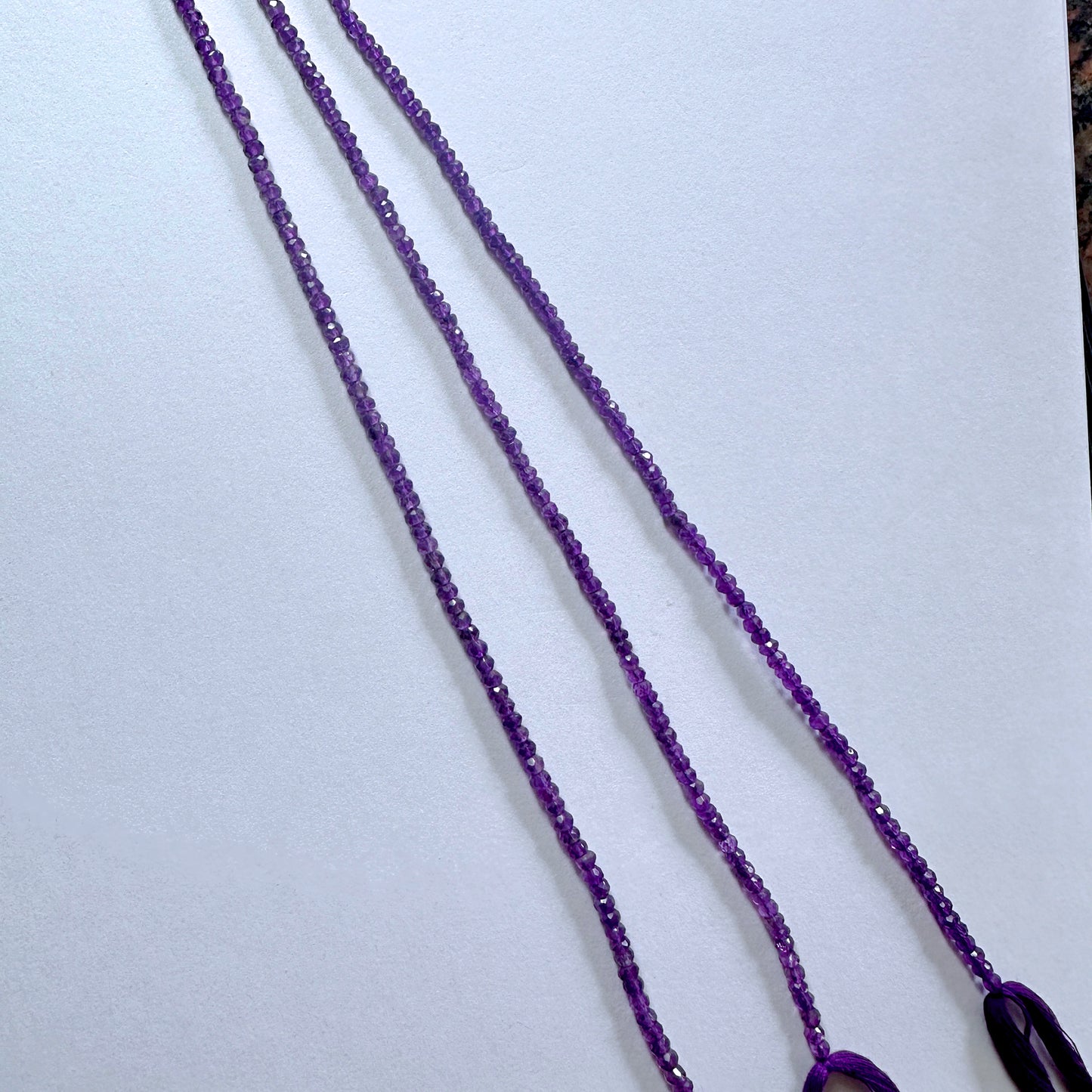 Faceted amethyst beads arranged in a 33cm strand with consistent sizing and elegant polish.