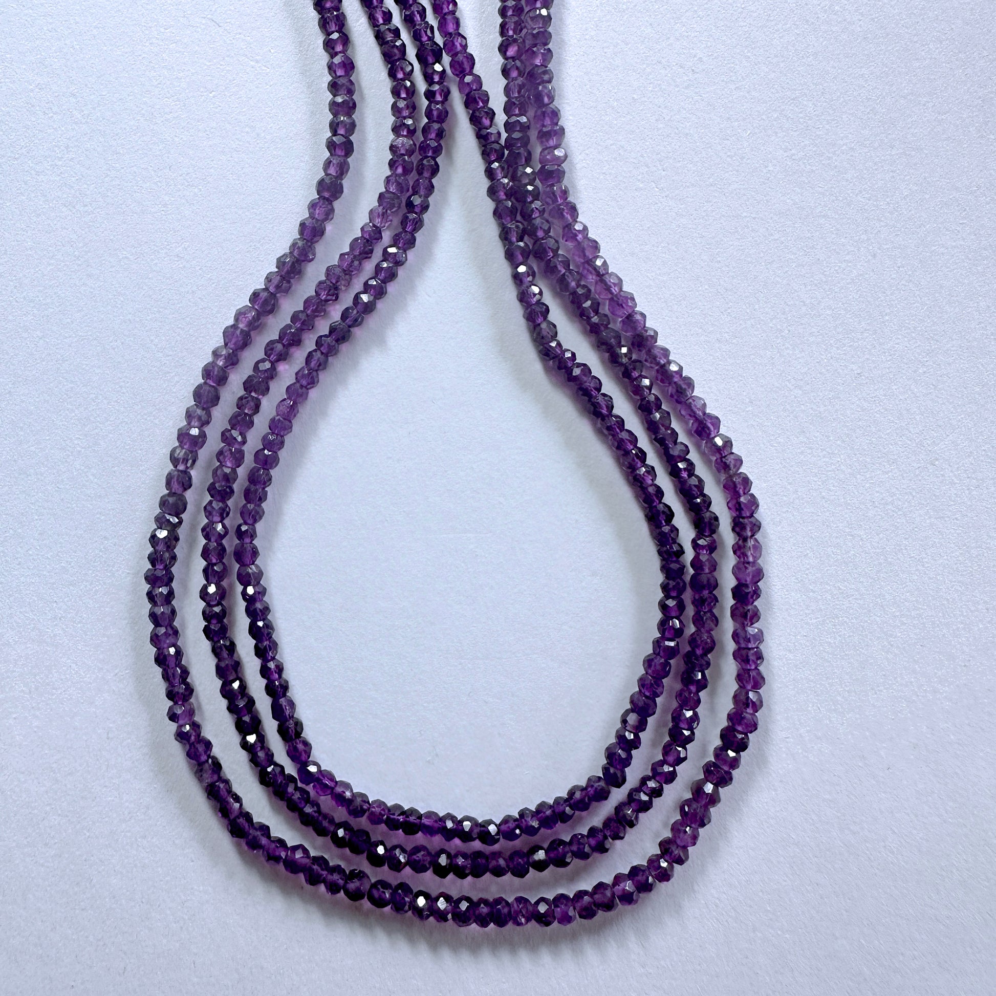 Amethyst faceted rondelle beads in 3.4-3.7mm size sparkle across a 33cm strand with rich purple tones.