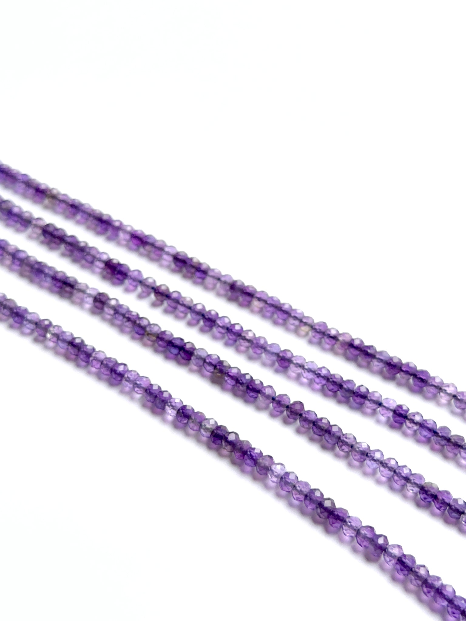 Amethyst stone beads in faceted rondelle shape with rich colour and clarity, perfect for handmade jewellery components.