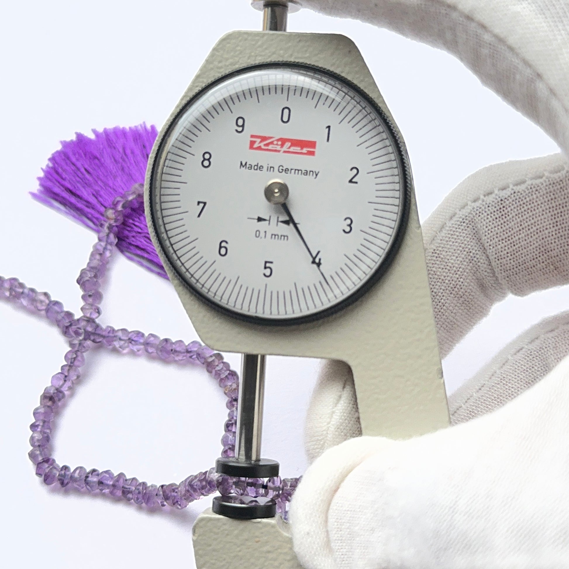 Vibrant Amethyst stone beads in faceted rondelle cut, displaying polished sparkle for jewellery designers.