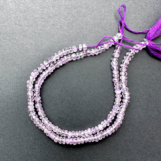 Amethyst faceted rondelle beads with deep purple tones arranged on a 17cm strand for jewellery making.