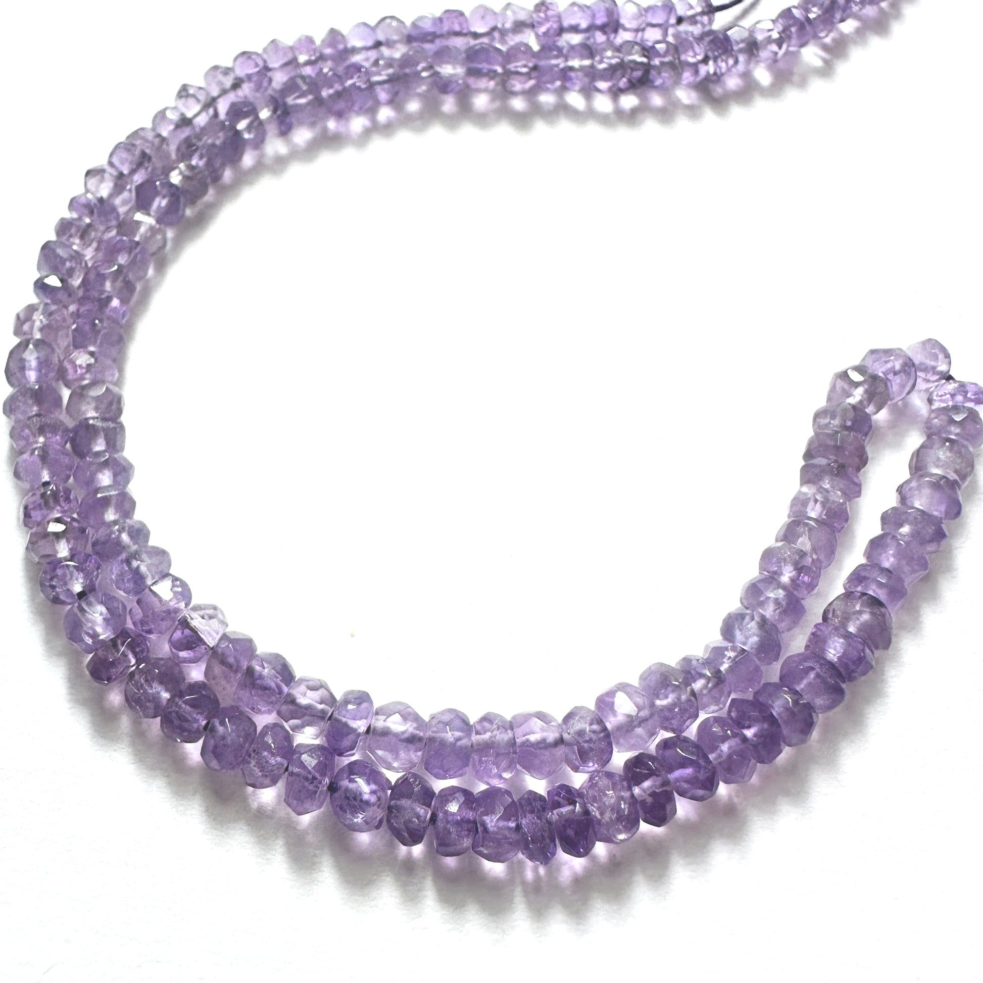 Amethyst rondelle beads with rich purple colour and faceted shine on a 36cm strand of natural gemstone beads.