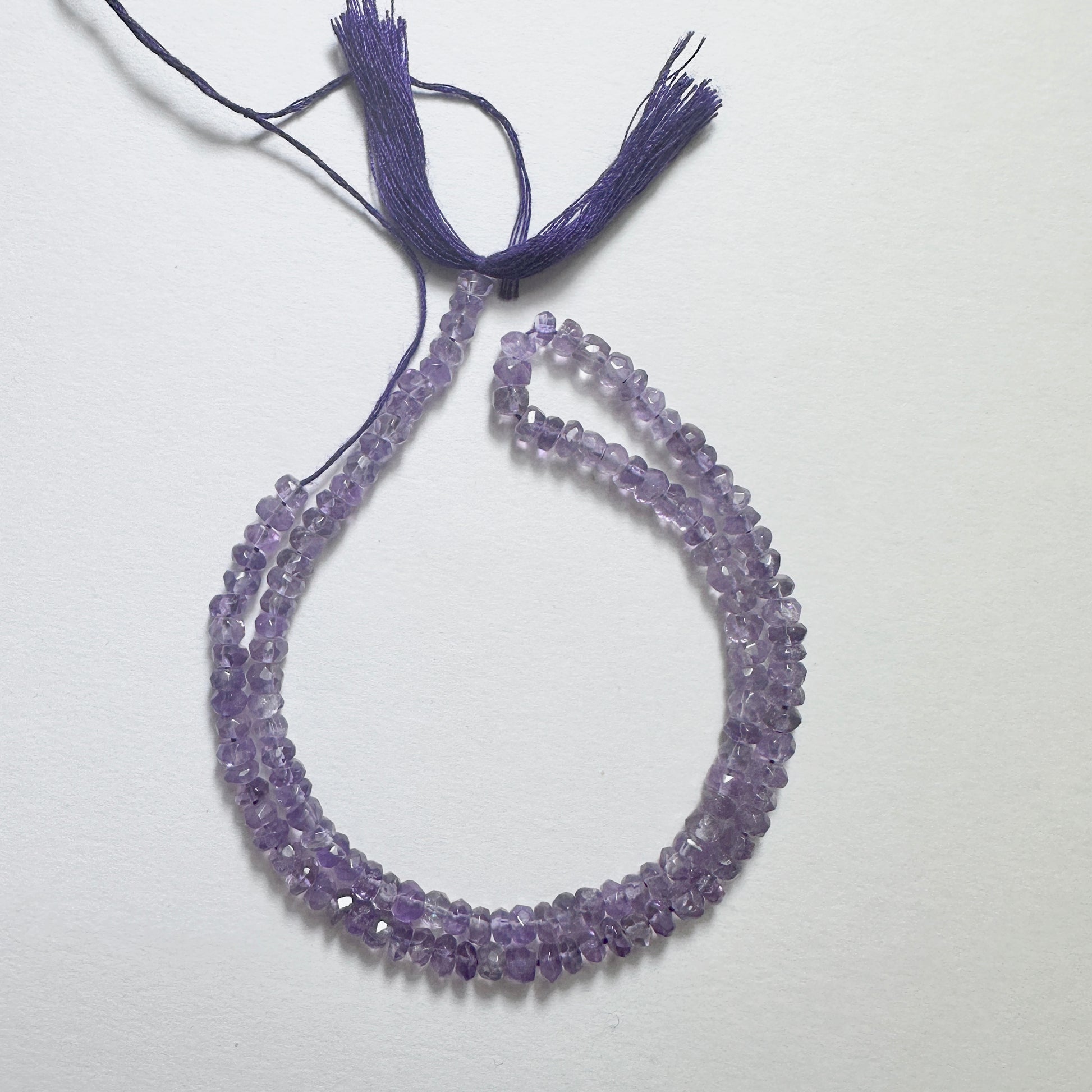 Handmade jewellery components with 4.1mm Amethyst beads arranged in a neat strand, ideal for elegant designs.