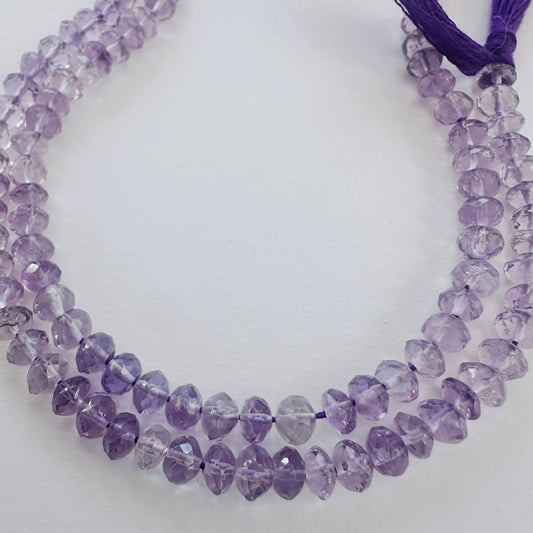 Close-up of Amethyst faceted rondelle beads with deep purple tones and sparkling facets.