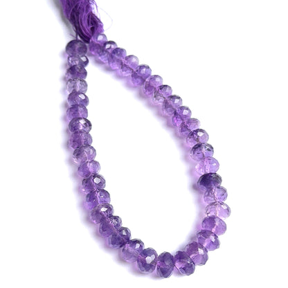Close‑up of amethyst faceted rondelles highlighting their polished cut and natural gemstone shine.