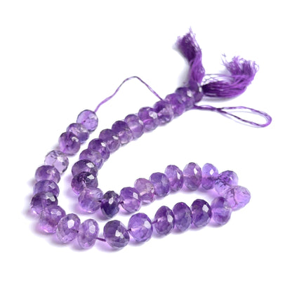 Large amethyst rondelle beads arranged neatly to showcase clarity, colour and precision faceting.