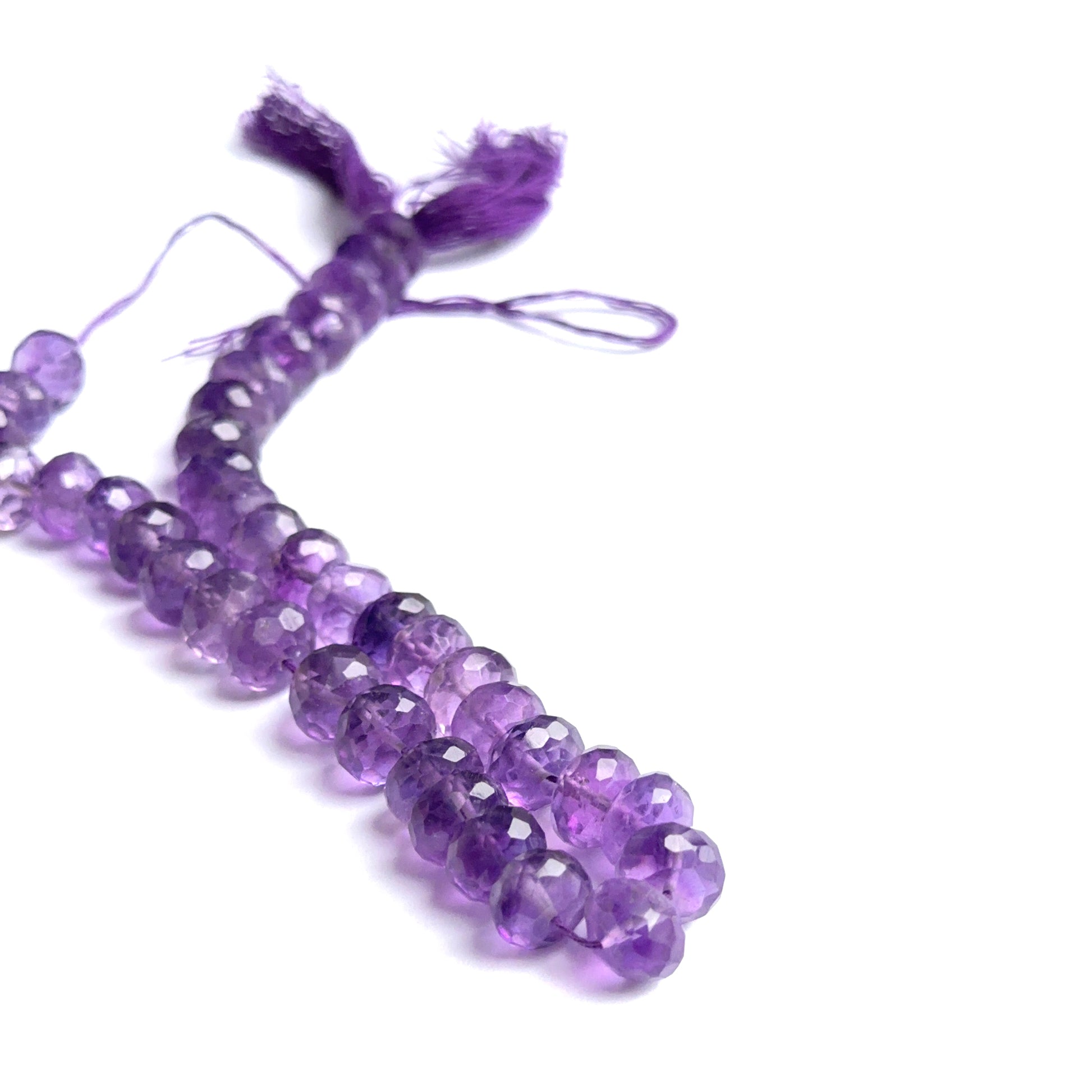 Amethyst faceted rondelles photographed to show brilliance, depth of colour and gemstone quality.