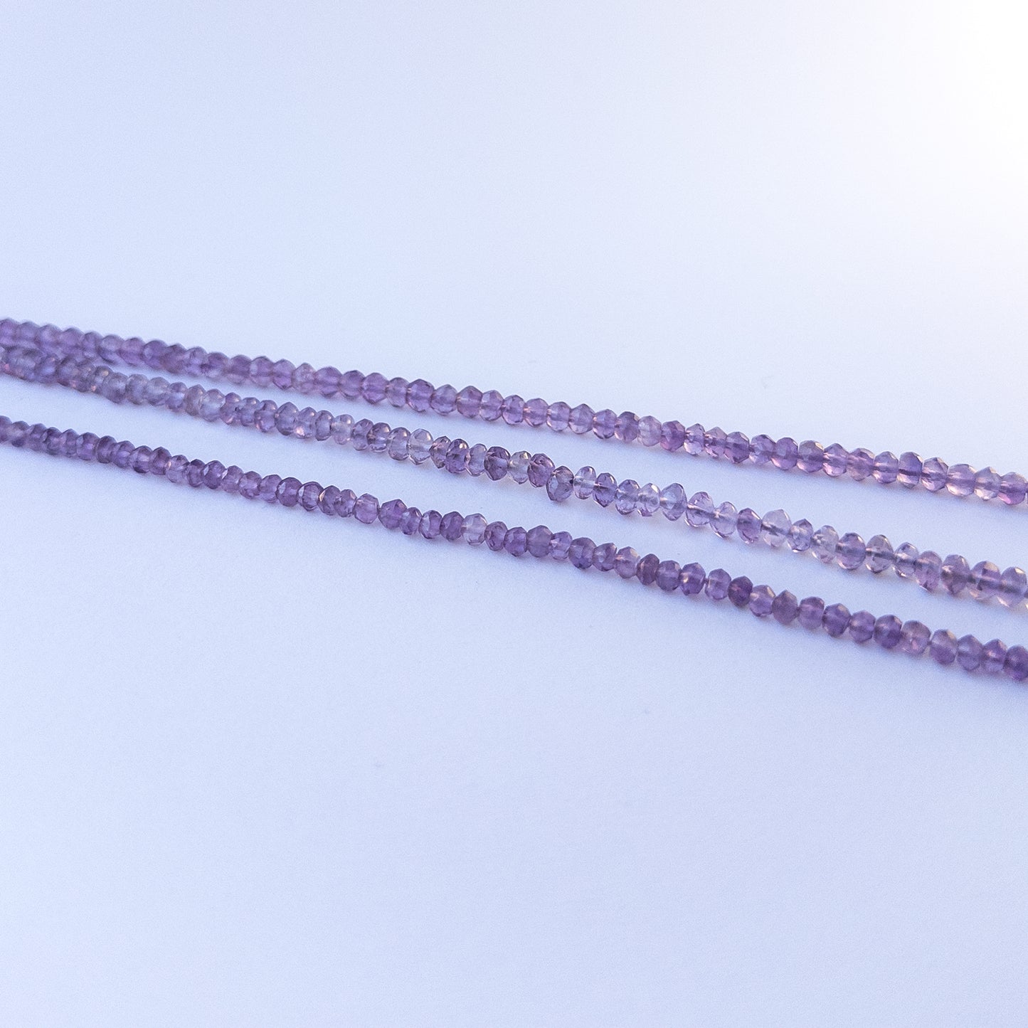High‑quality amethyst rondelle gemstone beads with bright shine and natural colour variation on a long strand.