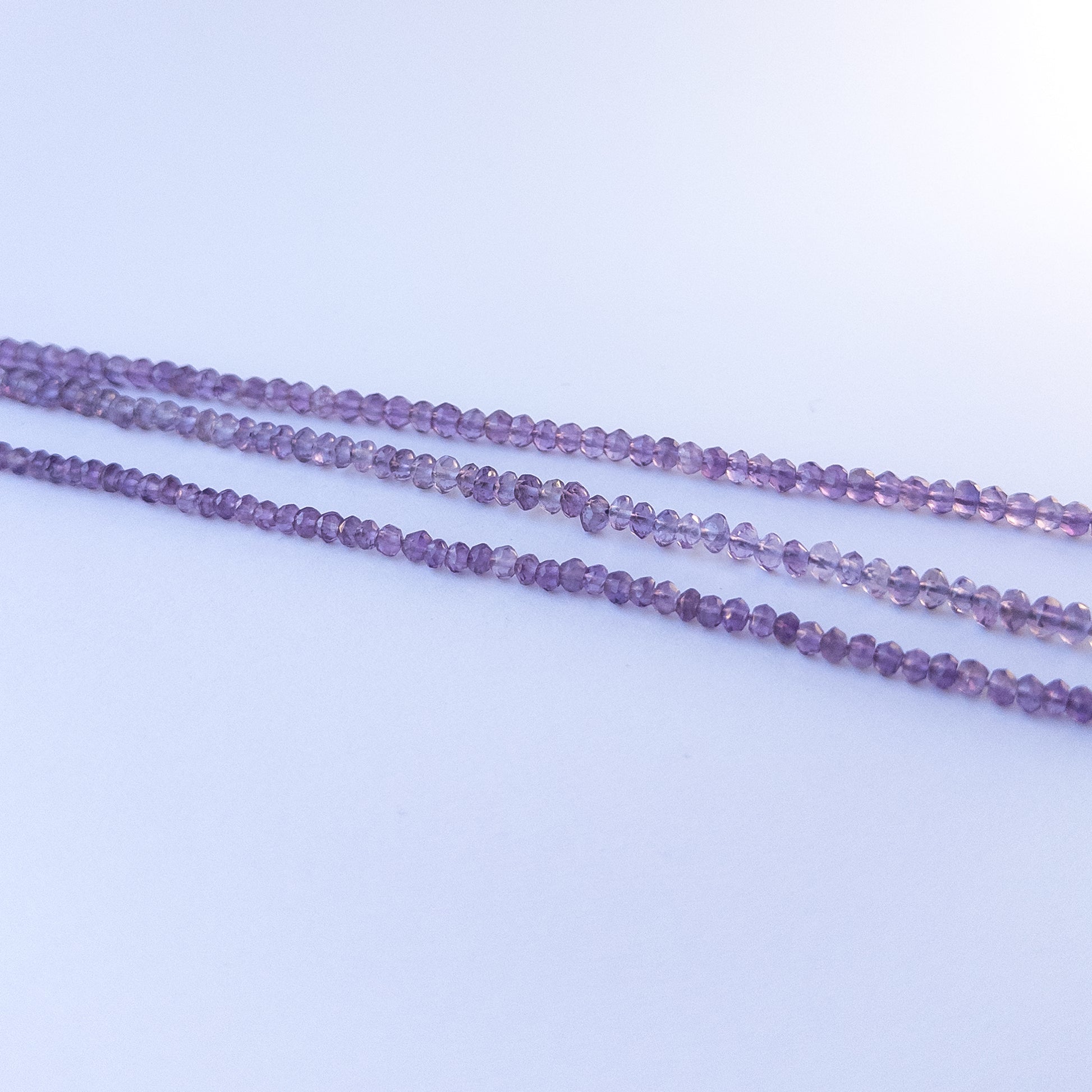 High‑quality amethyst rondelle gemstone beads with bright shine and natural colour variation on a long strand.