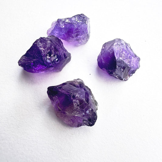 Close-up of raw Amethyst crystals showing natural texture and unpolished surfaces.