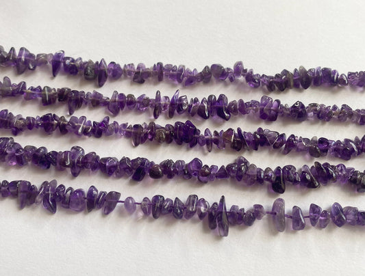 Amethyst smooth chip beads with deep violet tones arranged on a 45cm strand for natural gemstone designs.