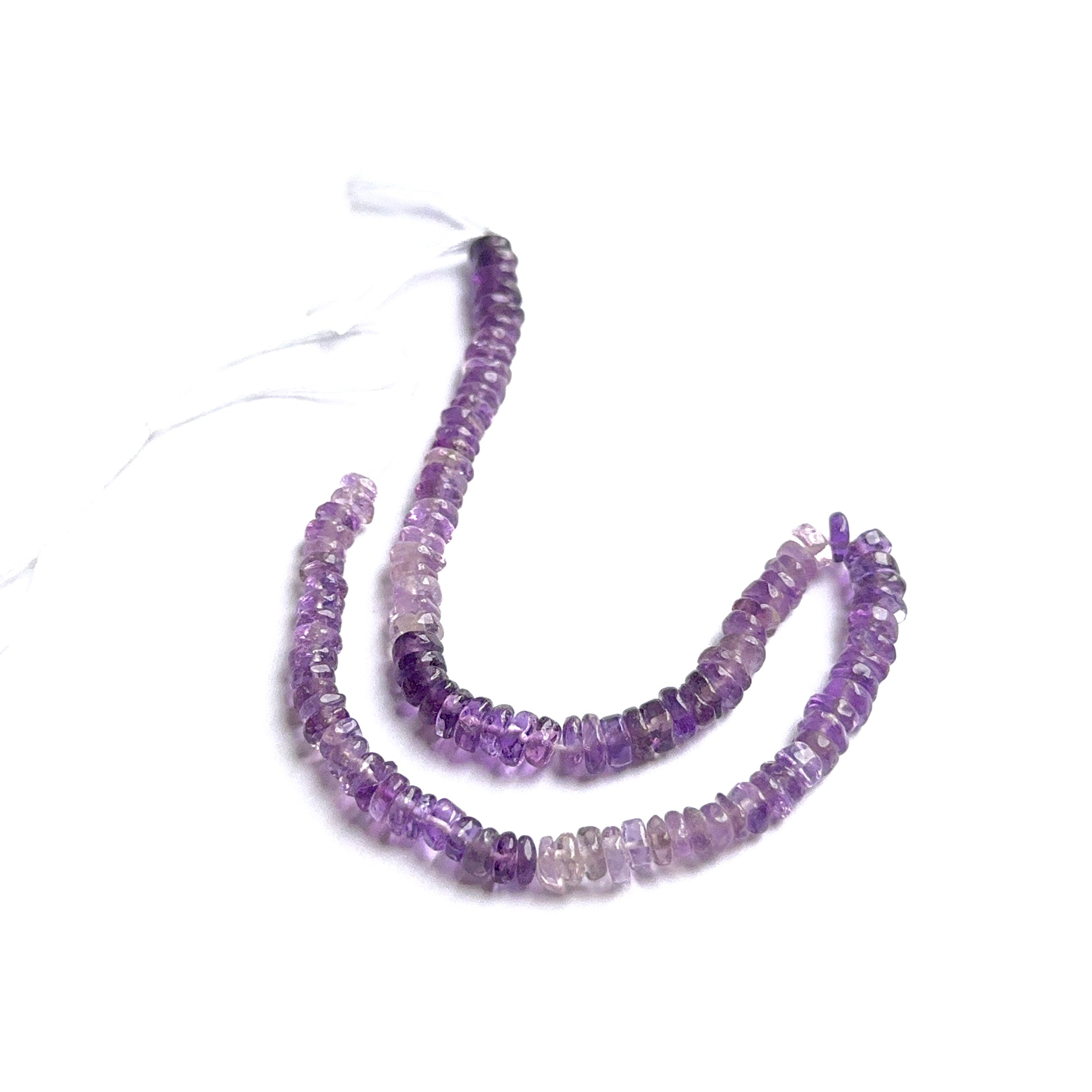 Amethyst heishi beads arranged neatly to showcase natural gemstone quality and smooth finish.