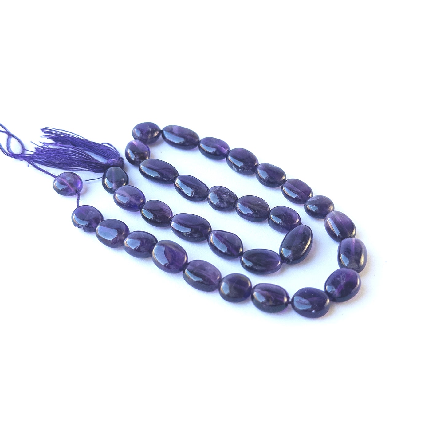 Authentic amethyst gemstone beads showcasing rich purple colour and glossy smooth oval finish.
