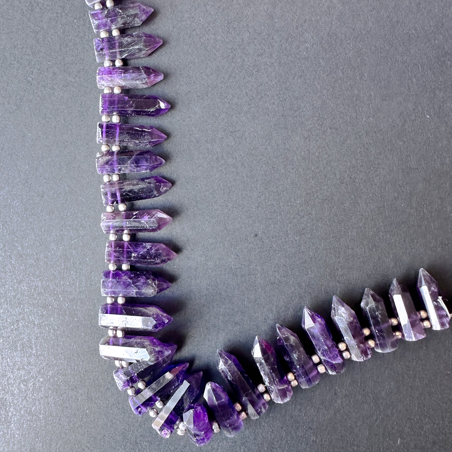 Stone beads arranged in a neat layout showcasing craftsmanship, colour consistency, and polished surface.