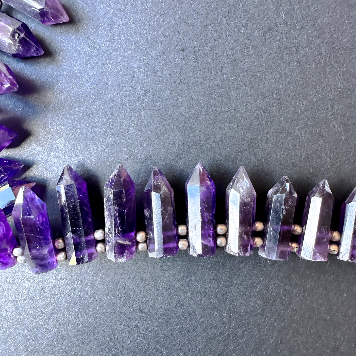 Smooth pencil-shaped amethyst beads.