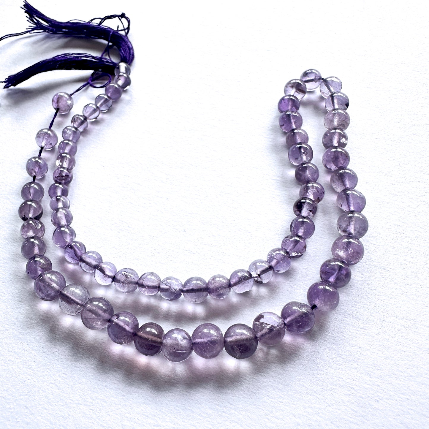 Natural gemstone beads featuring Amethyst with polished finish and consistent round cut.
