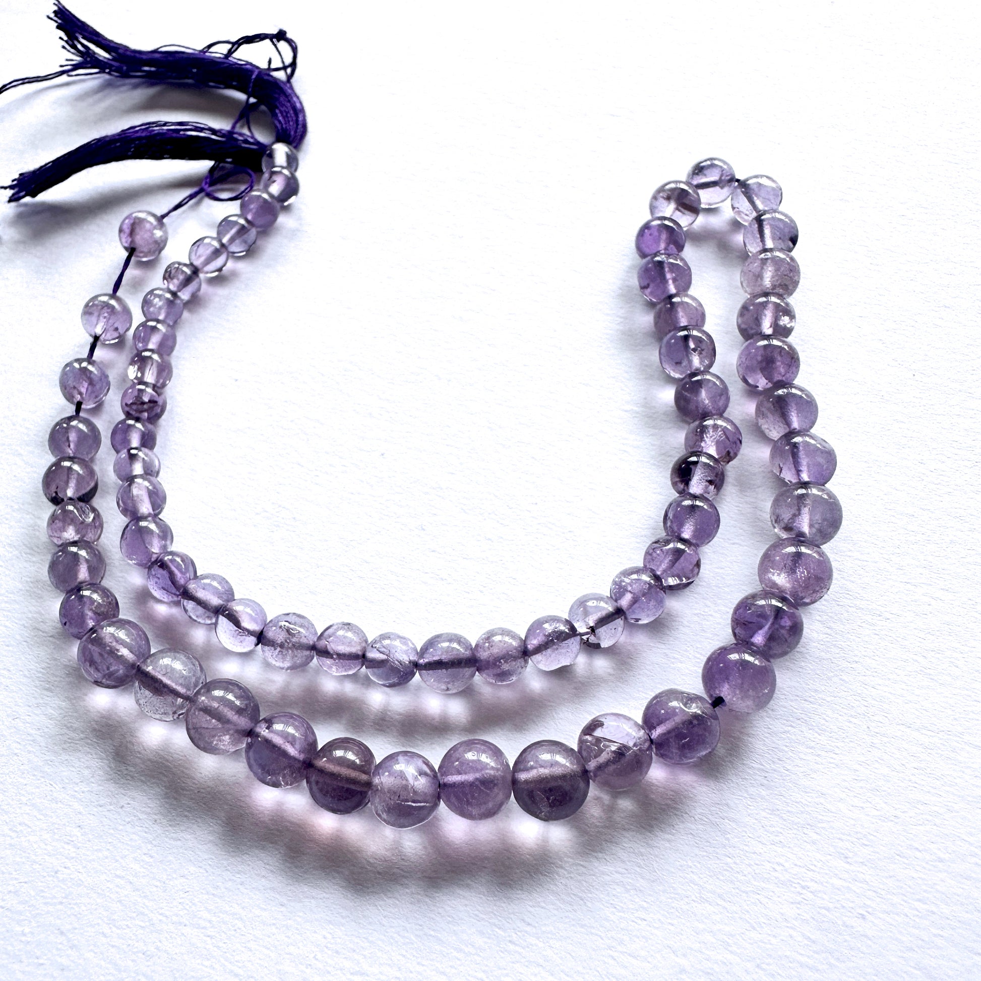 Natural gemstone beads featuring Amethyst with polished finish and consistent round cut.