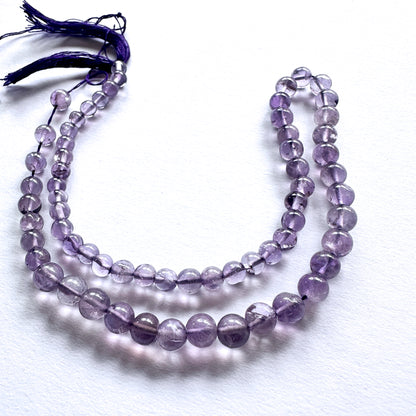 Natural gemstone beads featuring Amethyst with polished finish and consistent round cut.
