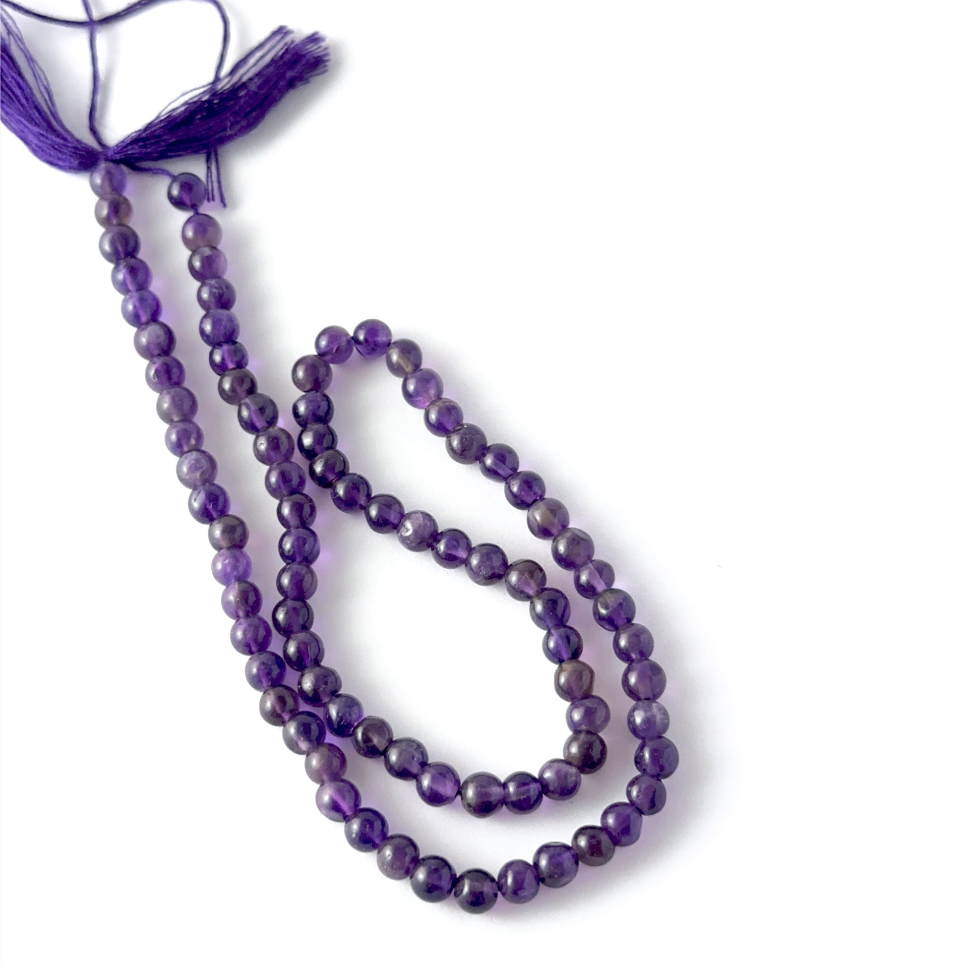 Amethyst round beads with natural lavender hues and gentle lustre, ideal for authentic stone beads in creative jewellery designs.