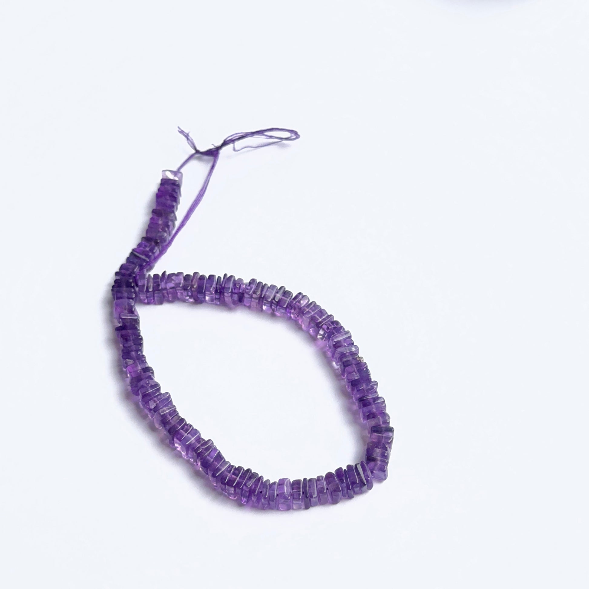 Amethyst smooth square heishi beads photographed to show clarity, deep colour and natural gemstone beauty.