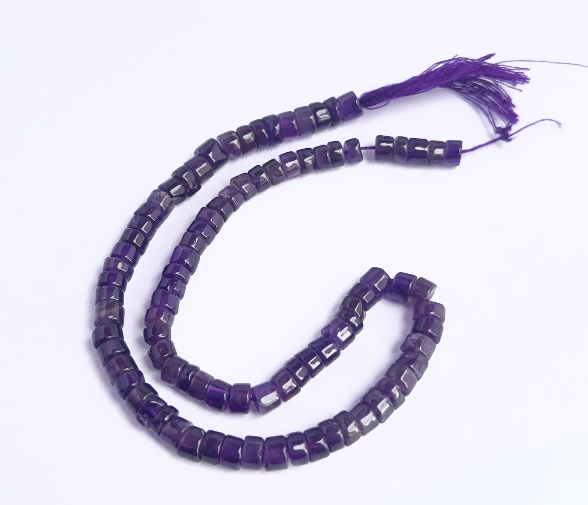 Amethyst smooth wheel beads in deep purple tones strung on a 30cm strand.