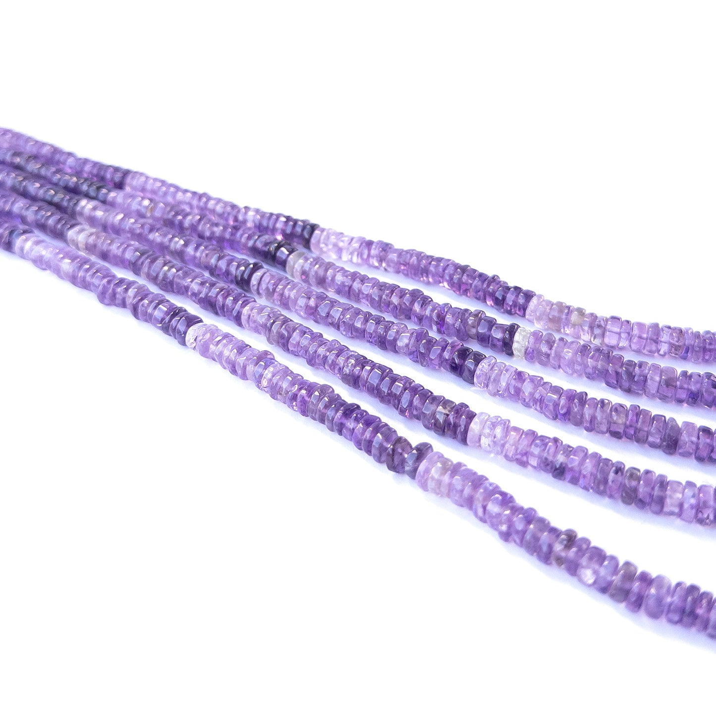 Handmade jewellery components featuring natural amethyst smooth wheel beads in a neatly aligned strand.