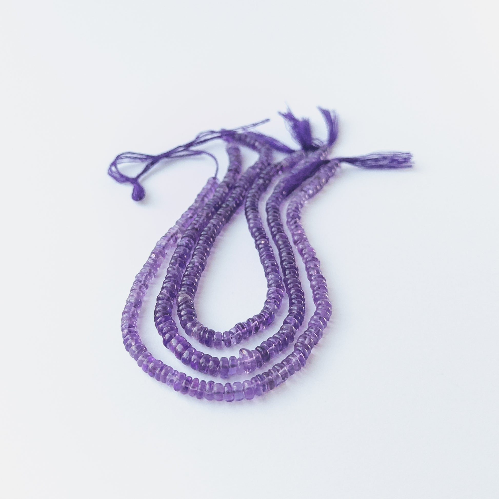 Genuine Amethyst gemstone beads with smooth wheel cut, perfect for artisan jewellery designs.