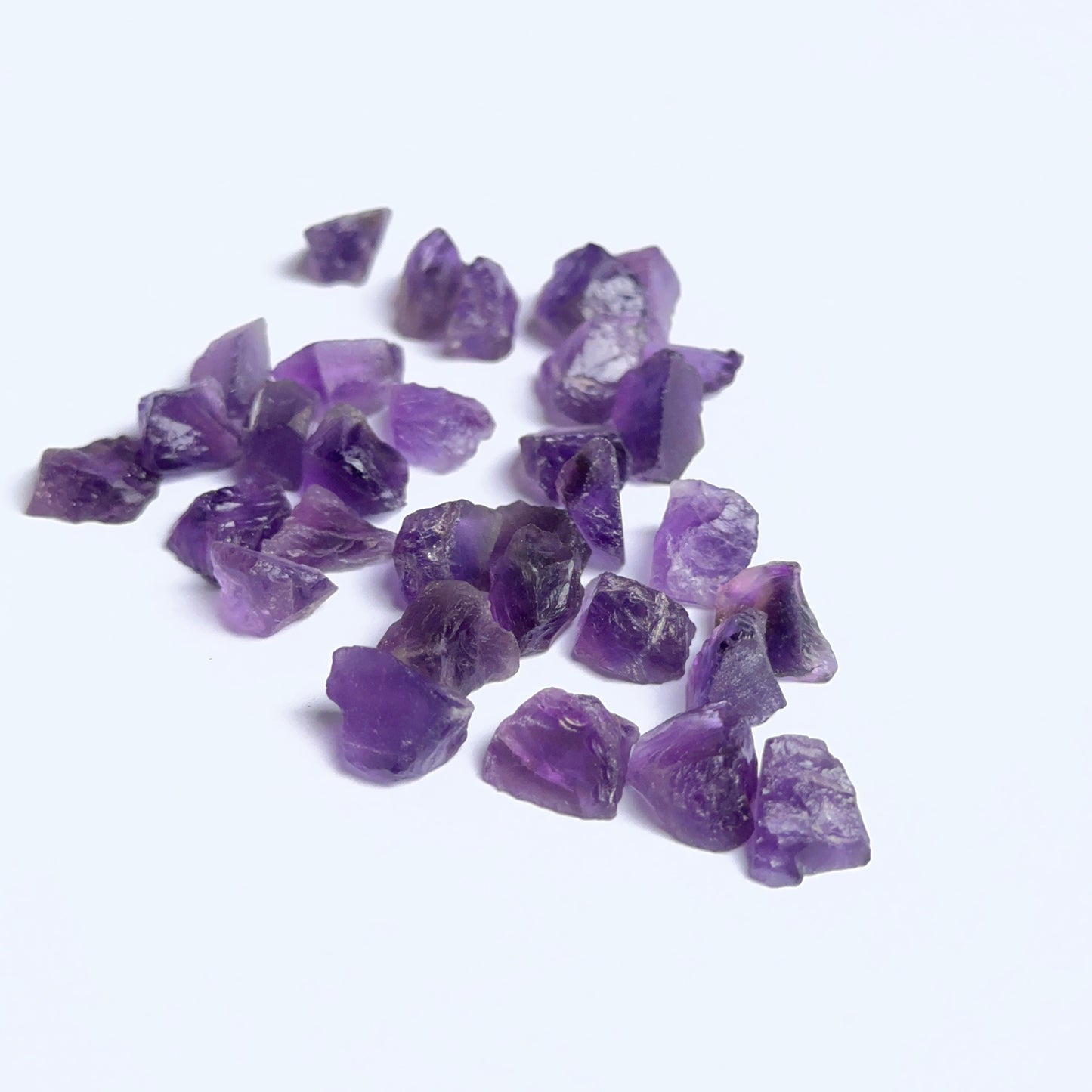 Close‑up of undrilled amethyst rough stones highlighting their organic shape and rich violet colour.