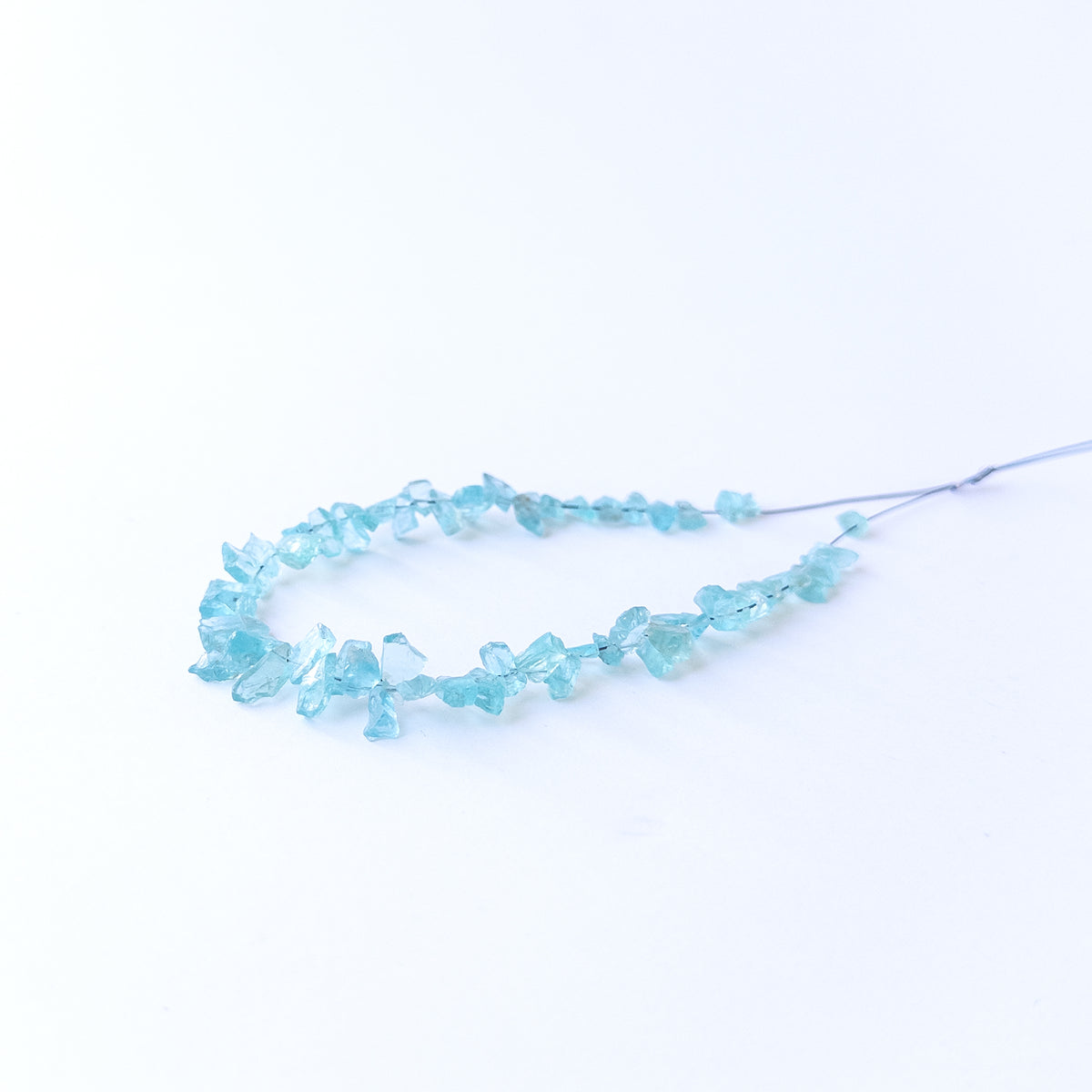 High‑quality Apatite gemstone beads with natural rough surfaces and bright ocean‑blue colour.