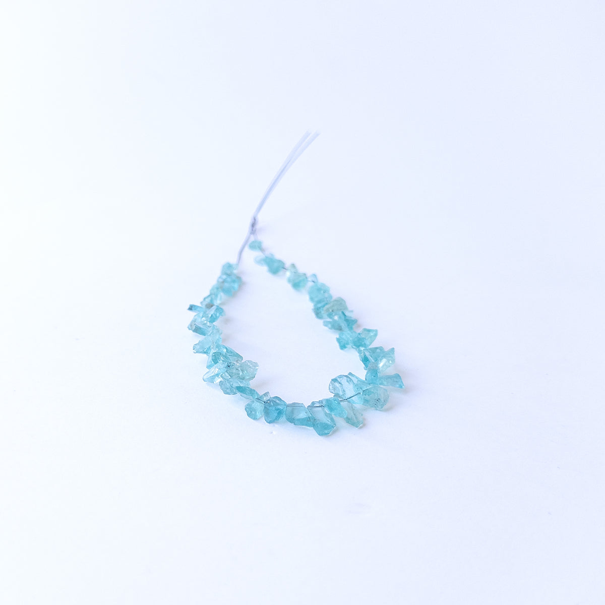 Authentic Apatite rough gemstone beads displaying vivid blue tones and organic uncut texture.