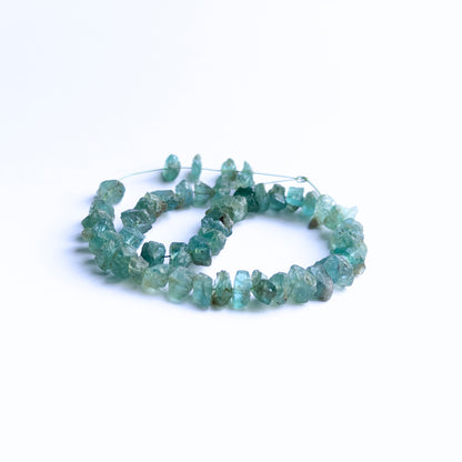 Apatite drilled rough gemstones showing raw edges, natural sparkle and uneven texture.
