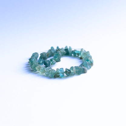 Blue Apatite rough beads arranged neatly, highlighting their earthy finish and 6–7mm size.